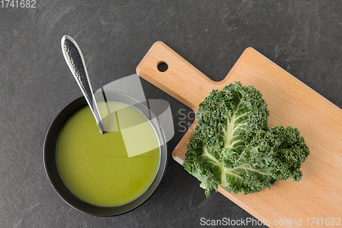Image of kale cabbage cream soup in bowl with spoon