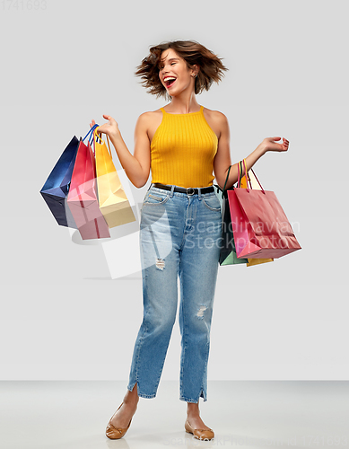 Image of happy smiling young woman with shopping bags