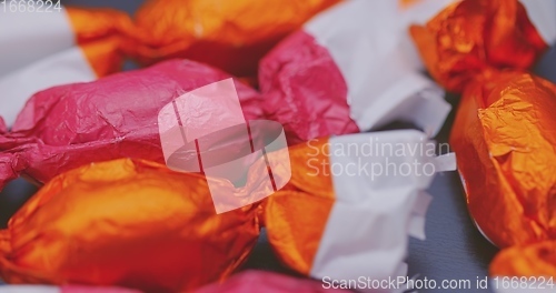 Image of Christmas candy lying on the table with camera in motion closeup