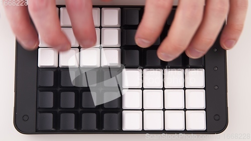 Image of Hands typing fast on Unlabeled keyboard