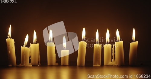 Image of Candles glowing against dark background