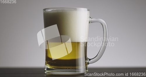 Image of Large mug of beer on the table slow motion footage