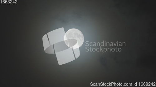 Image of Full moon against cloudy night sky