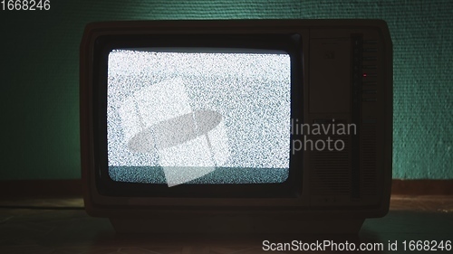 Image of Old TV agains green background
