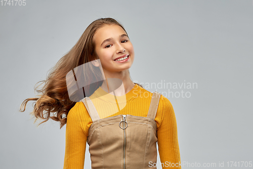 Image of young teenage girl with waving long hair