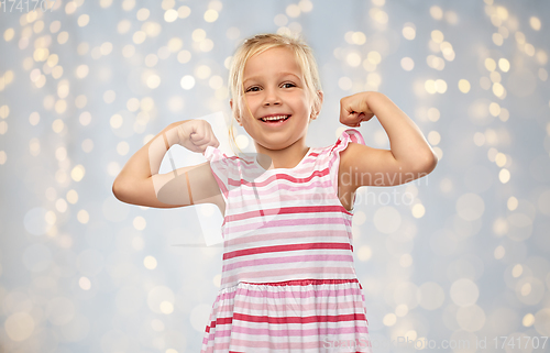 Image of smiling little girl showing her power