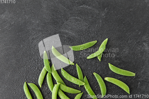 Image of peas on wet slate stone background