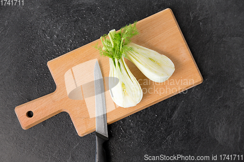 Image of fennel and kitchen knife on wooden cutting board