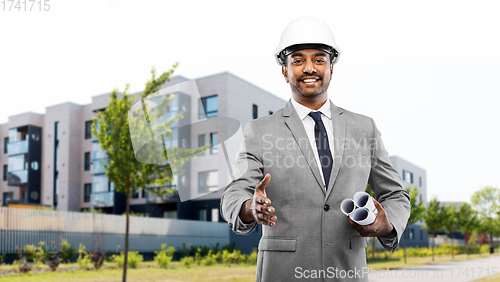 Image of architect giving hand for handshake on city street