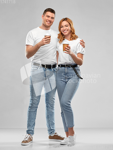 Image of portrait of happy couple with takeaway coffee cups