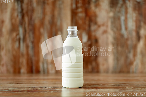 Image of bottle of milk on wooden table
