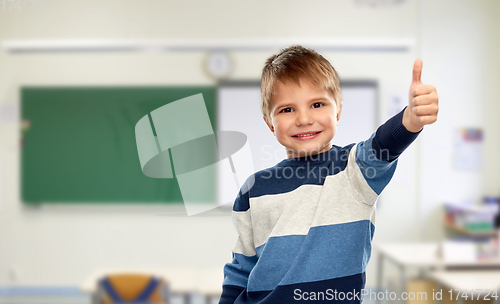 Image of little boy showing thumbs up at school