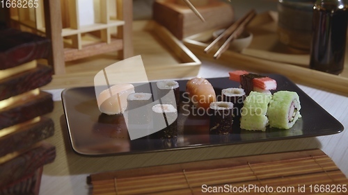 Image of Filling plate with japanese sushi closeup