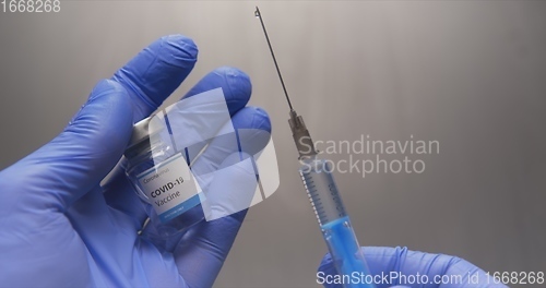 Image of Vaccine in human hands closeup footage