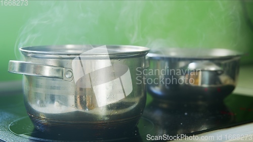 Image of Steam or vapor clouds rising from boiling oil