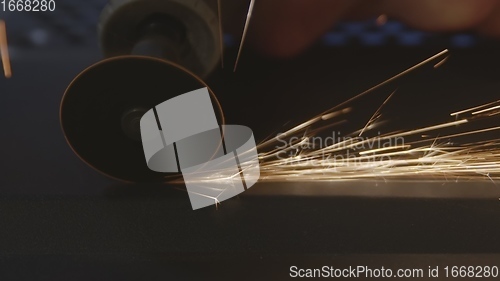 Image of Steel cutter with sparks while cutting steel bar
