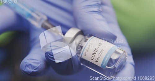 Image of Vaccine in human hands closeup footage