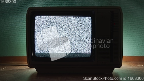 Image of Old TV agains green background