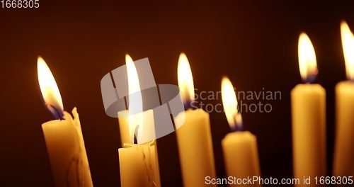 Image of Candles glowing against dark background