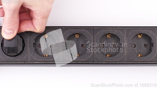 Image of Filling Electric socket holes with electric plugs closeup footage