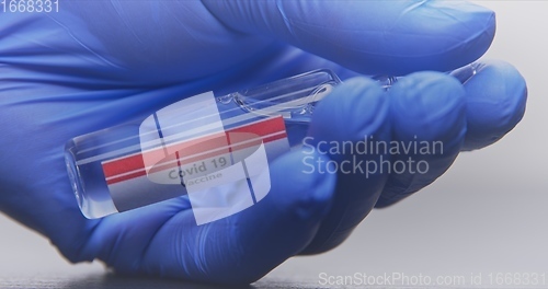 Image of Vaccine in human hands closeup footage