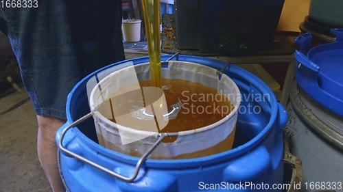 Image of Raw honey pouring out closeup footage