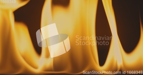 Image of Fire dancing against dark background 120fps slow motion loopable footage