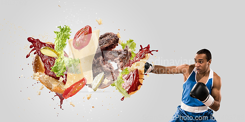 Image of Burger\'s crashing by the boxer isolated on white background