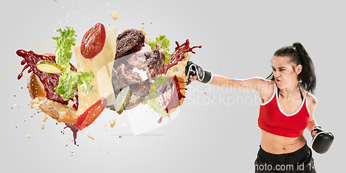 Image of Burger\'s crashing by the boxer isolated on white background