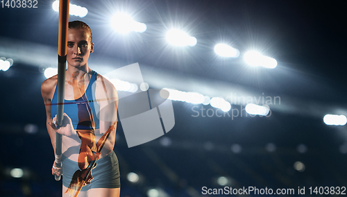 Image of Female pole vaulter training or performing at the stadium