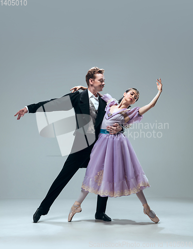 Image of Contemporary ballroom dancers on grey studio background