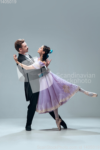 Image of Contemporary ballroom dancers on grey studio background