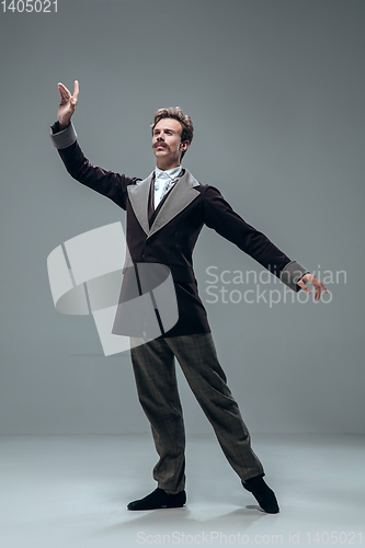 Image of Contemporary ballroom dancer on grey studio background