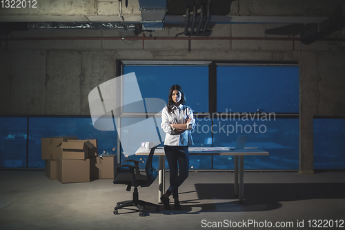 Image of young female architect and engineer on construction site