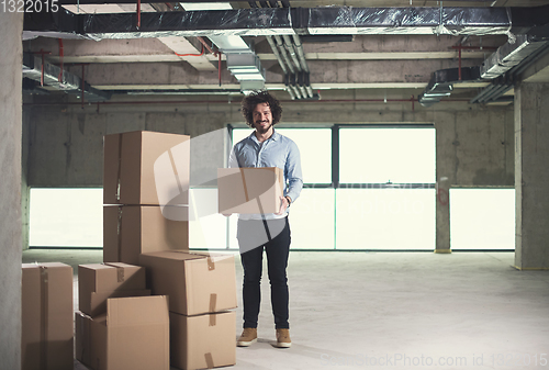 Image of portrait of young businessman on construction site