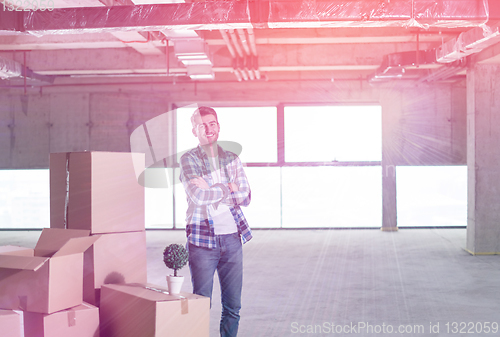 Image of portrait of young businessman on construction site