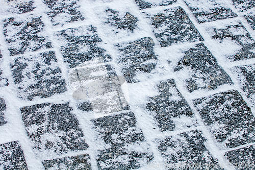 Image of Cobblestone pavement covered with snow and ice