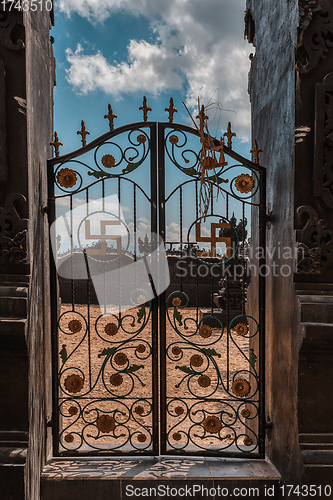 Image of iron gate decorated with swastika symbols, Bali Indonesia