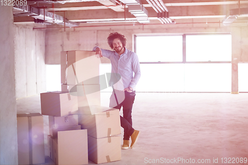 Image of portrait of young businessman on construction site