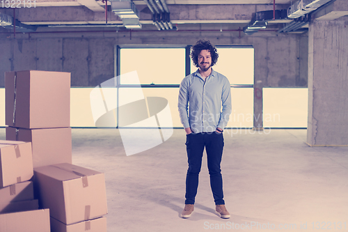 Image of portrait of young businessman on construction site