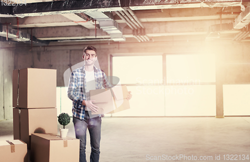 Image of portrait of young businessman on construction site