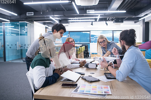 Image of multiethnic business team learning about drone technology