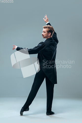 Image of Contemporary ballroom dancer on grey studio background