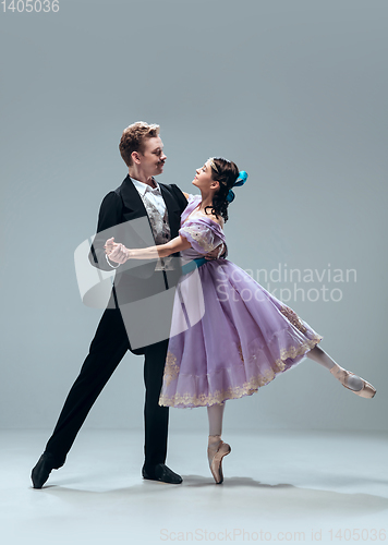 Image of Contemporary ballroom dancers on grey studio background