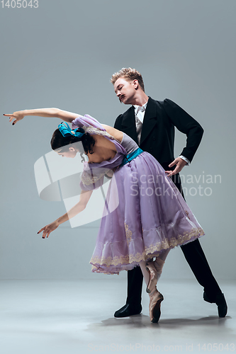 Image of Contemporary ballroom dancers on grey studio background