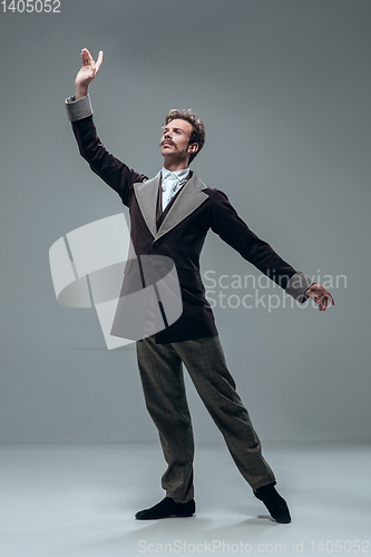 Image of Contemporary ballroom dancer on grey studio background