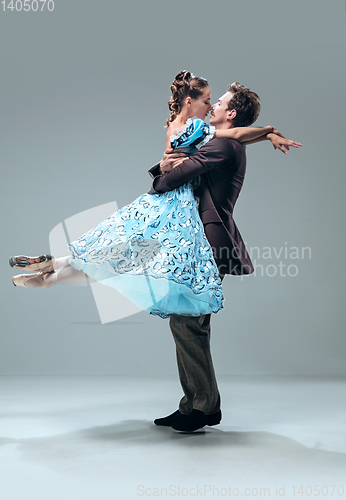 Image of Contemporary ballroom dancers on grey studio background