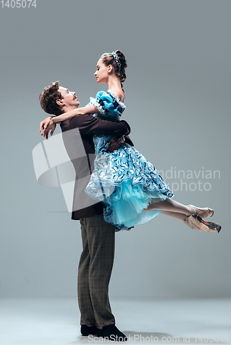 Image of Contemporary ballroom dancers on grey studio background