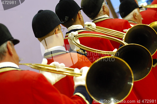 Image of musicians playing music on hunting horn 