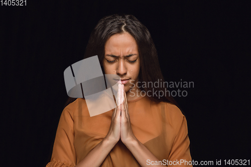 Image of Close up portrait of young woman isolated on black studio background